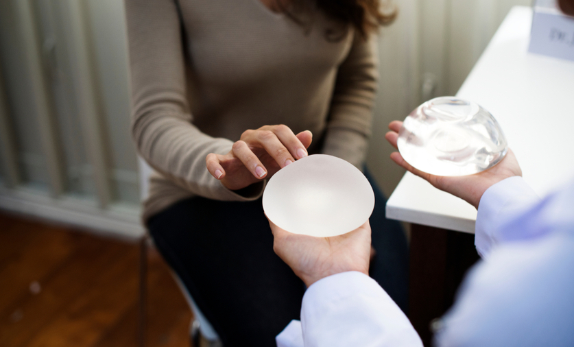Doctor showing breast implants to patient
